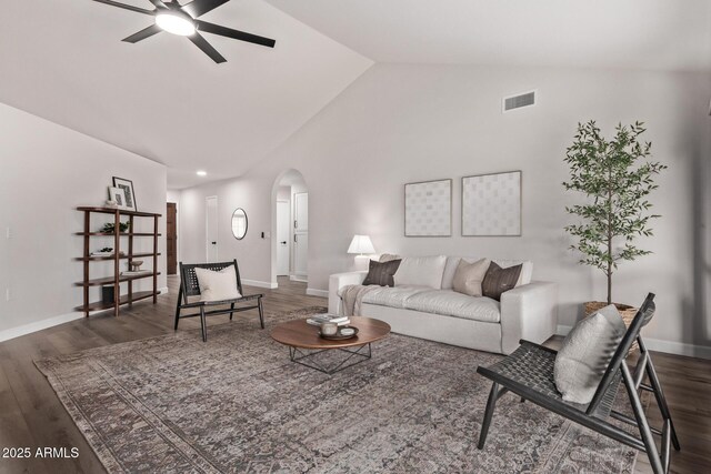 living room featuring lofted ceiling, ceiling fan, and dark wood-type flooring