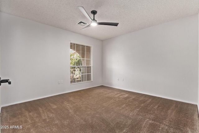 carpeted spare room with a textured ceiling and ceiling fan