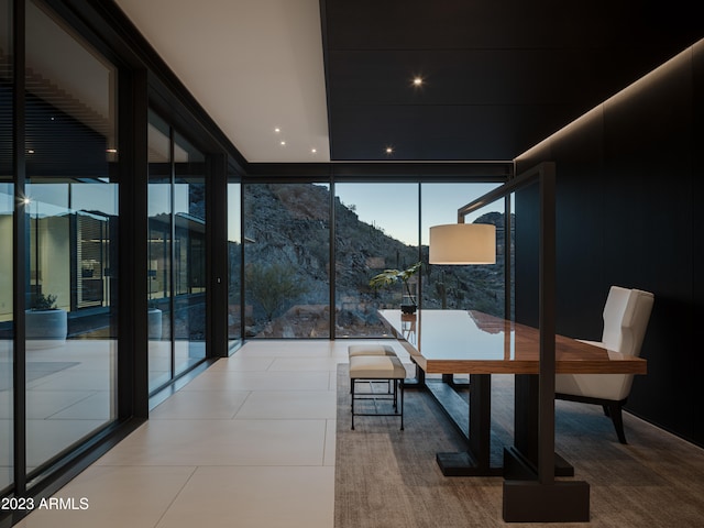 interior space with expansive windows and a mountain view