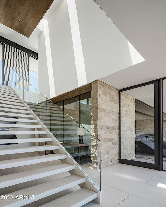 staircase featuring tile patterned floors and plenty of natural light