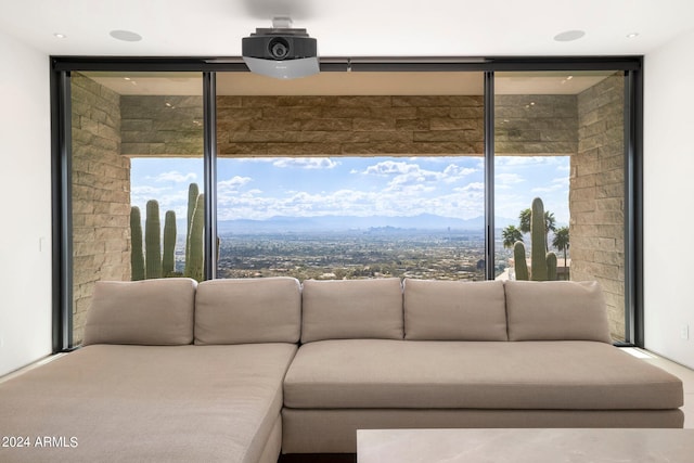 unfurnished living room with floor to ceiling windows, a mountain view, and a wealth of natural light