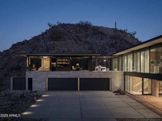 view of front of property with exterior kitchen and a mountain view