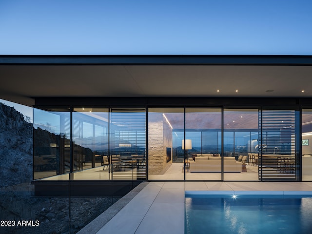 pool at dusk featuring a patio area