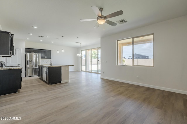 8518 S 8th Ln, Phoenix, AZ 85041 - kitchen featuring stainless steel fridge with ice dispenser, a sink, dark cabinets, a ceiling fan, and light wood-type flooring