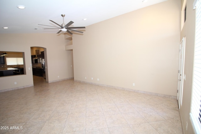 5437 W Bluefield Ave, Glendale, AZ 85308 - unfurnished living room with arched walkways, a ceiling fan, recessed lighting, and light tile patterned floors