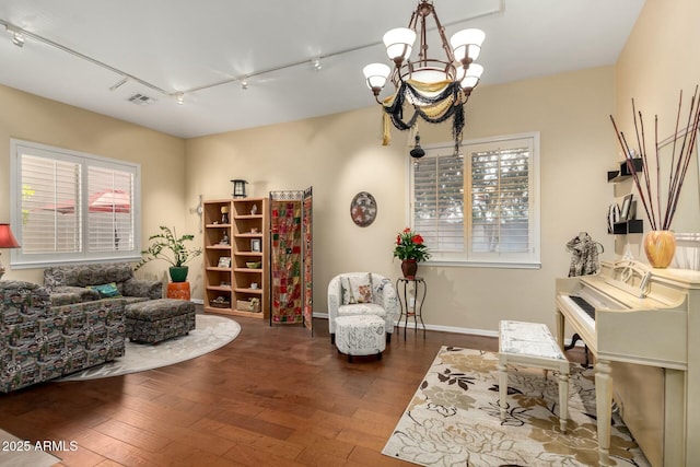 sitting room featuring a chandelier, visible vents, baseboards, and hardwood / wood-style flooring