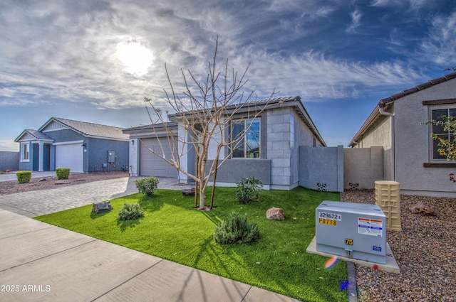 view of front of property with a garage and a front lawn