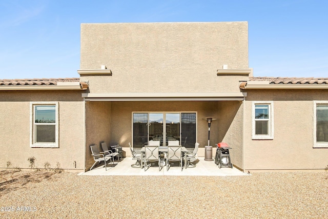 rear view of property featuring a patio