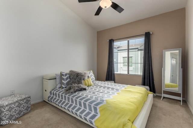 bedroom featuring ceiling fan, light colored carpet, and vaulted ceiling