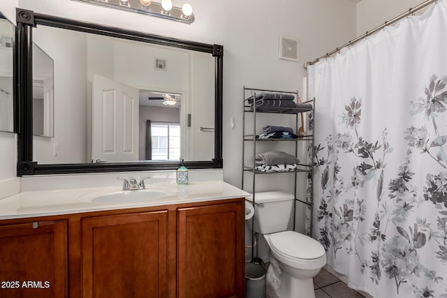 bathroom featuring toilet, ceiling fan, tile patterned flooring, vanity, and curtained shower