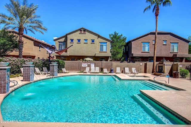 view of swimming pool featuring pool water feature, central AC unit, and a patio area