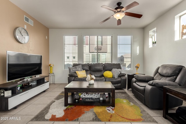 tiled living room featuring ceiling fan