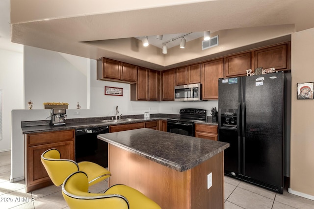 kitchen with light tile patterned floors, sink, and black appliances