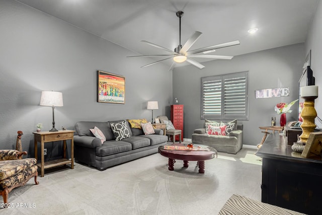 living room featuring baseboards, carpet floors, and ceiling fan