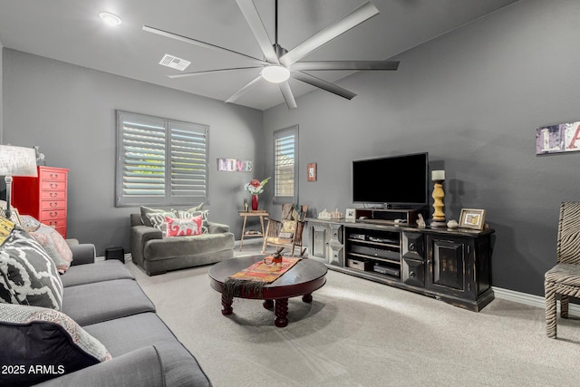 carpeted living area featuring visible vents, baseboards, and a ceiling fan