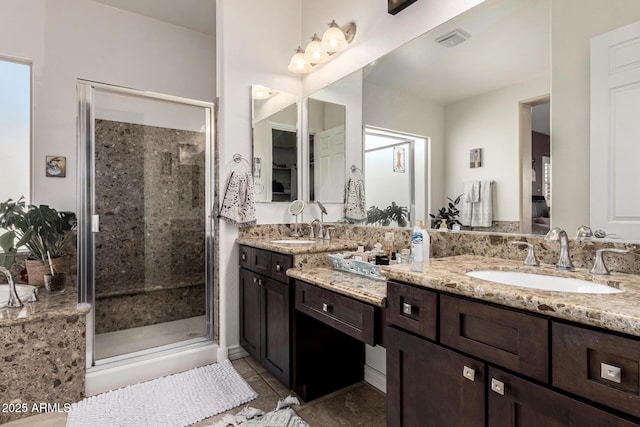 full bathroom with tile patterned flooring, visible vents, a shower stall, and vanity