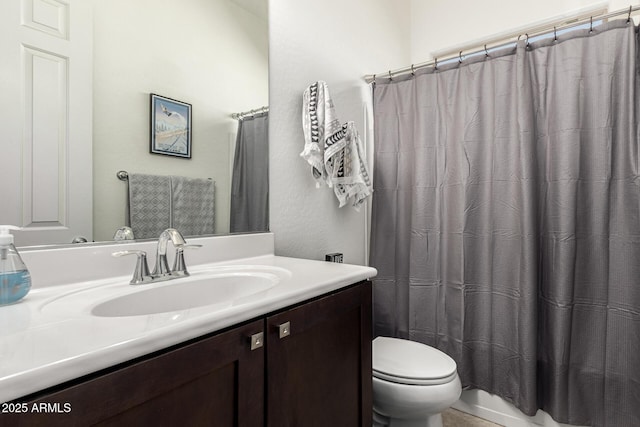 bathroom with curtained shower, toilet, and vanity