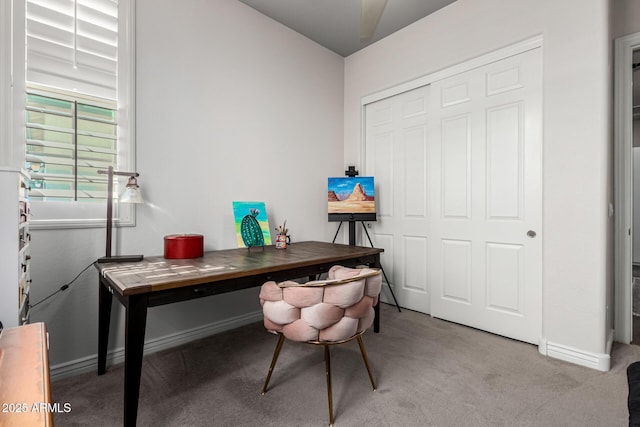 home office featuring baseboards and light colored carpet