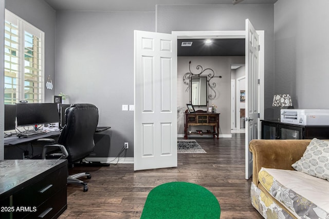 home office with dark wood finished floors, visible vents, and baseboards
