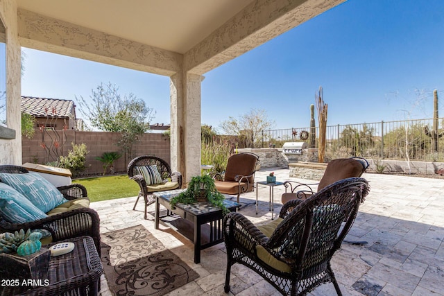 view of patio with an outdoor living space, area for grilling, and a fenced backyard