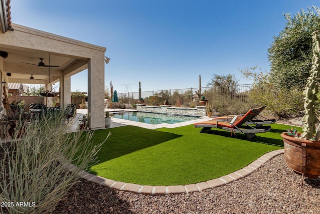 view of yard with a patio, a fenced backyard, a fenced in pool, and ceiling fan