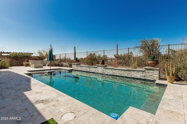 view of swimming pool featuring a fenced in pool, a patio, and a fenced backyard