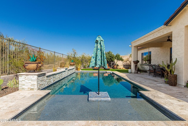 view of pool featuring ceiling fan, a fenced in pool, a patio, and a fenced backyard