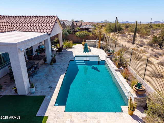 view of swimming pool featuring a mountain view, a fenced in pool, a patio, and a fenced backyard