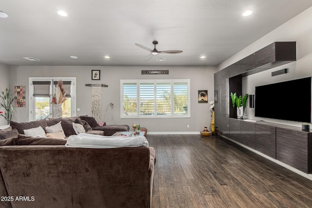 living area featuring baseboards, visible vents, recessed lighting, dark wood-style flooring, and ceiling fan