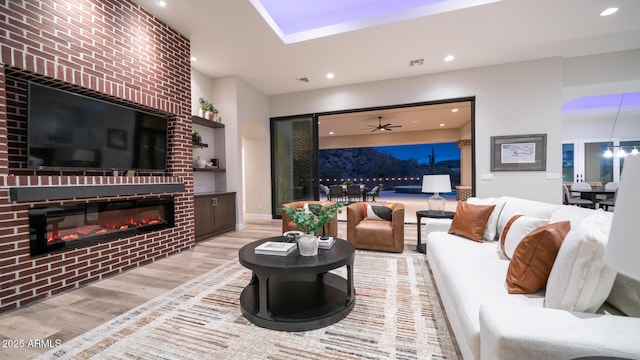 living room with ceiling fan and light hardwood / wood-style floors