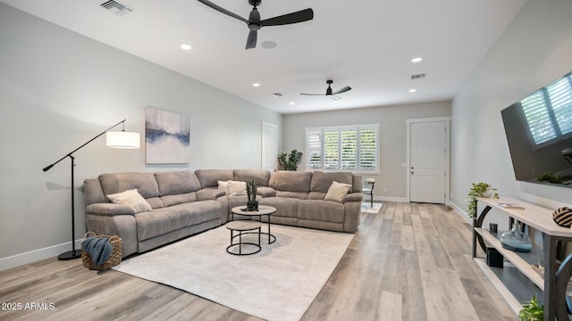 living room with ceiling fan and light wood-type flooring