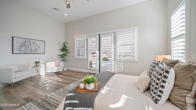 interior space with hardwood / wood-style floors and ceiling fan