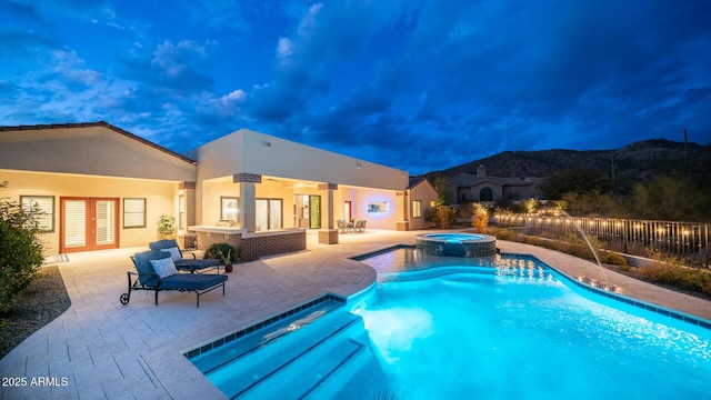 view of swimming pool with french doors, a patio, and an in ground hot tub