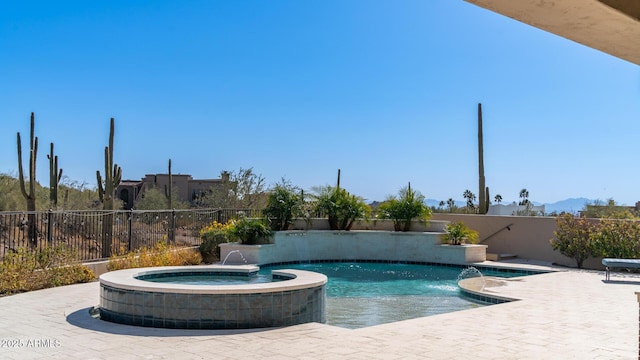 view of swimming pool featuring pool water feature, an in ground hot tub, and a patio