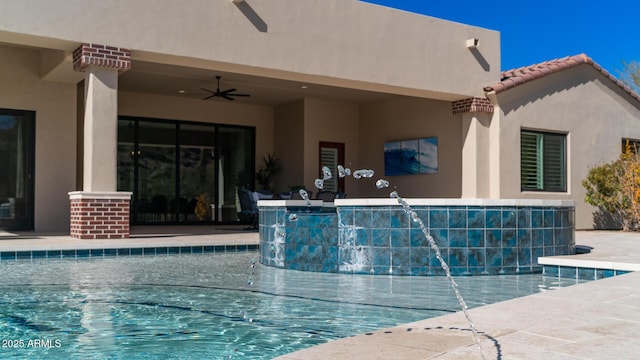 view of swimming pool featuring pool water feature and ceiling fan