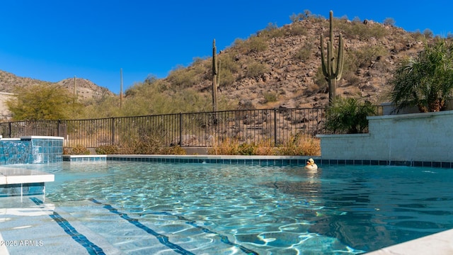 view of swimming pool featuring a mountain view and pool water feature