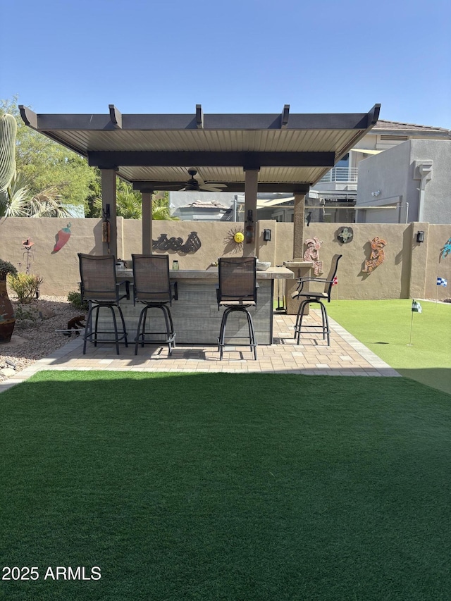 view of patio featuring a fenced backyard and outdoor dry bar