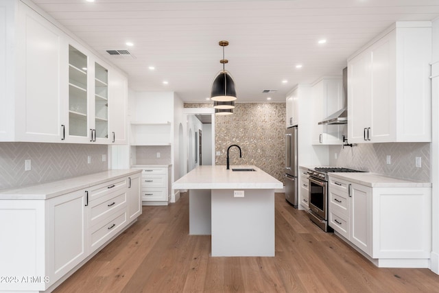 kitchen with white cabinetry, high end appliances, and decorative light fixtures