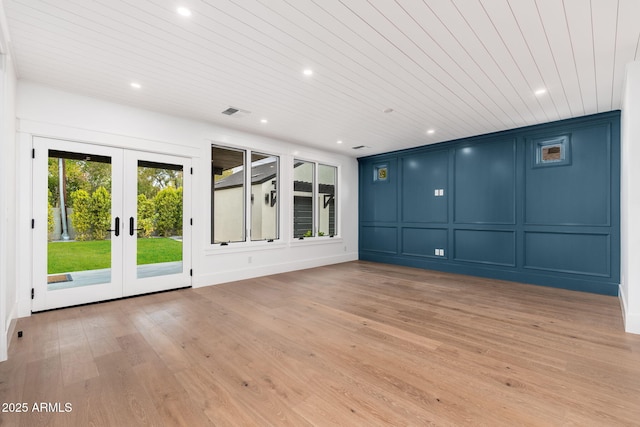 spare room featuring wooden ceiling, french doors, and light wood-type flooring