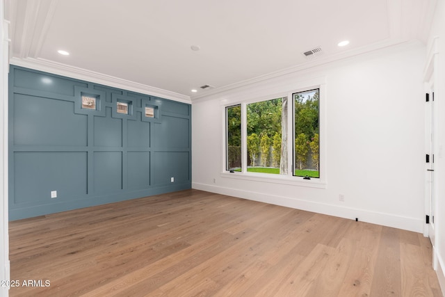 unfurnished room with crown molding and light hardwood / wood-style flooring