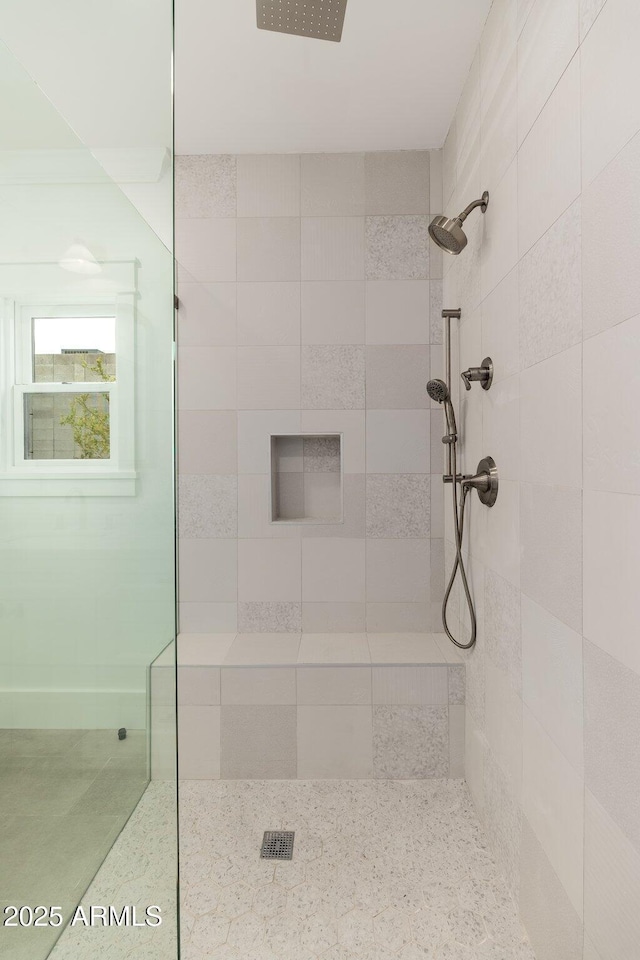 bathroom with a tile shower