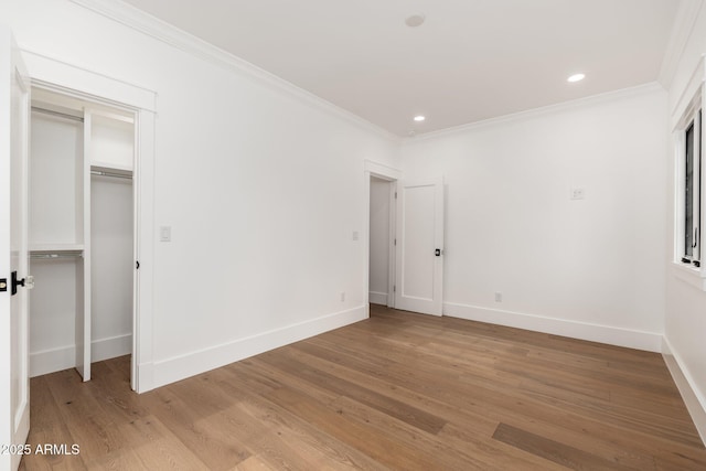 unfurnished bedroom featuring crown molding and light wood-type flooring