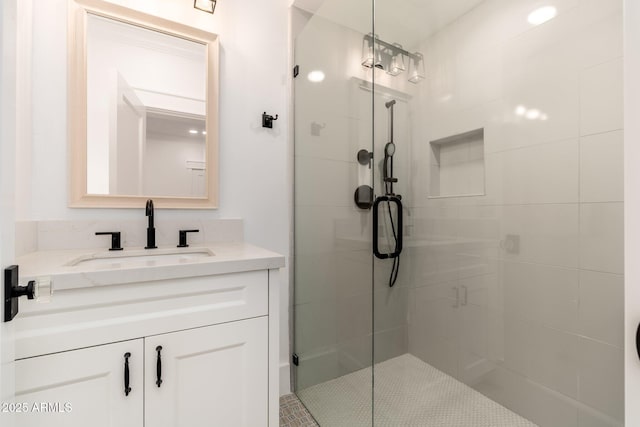 bathroom with walk in shower and vanity