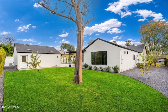 back of house with a lawn