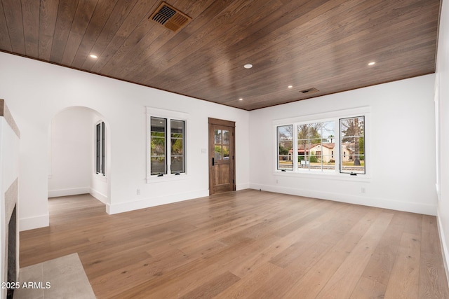 spare room featuring plenty of natural light, wooden ceiling, and light wood-type flooring