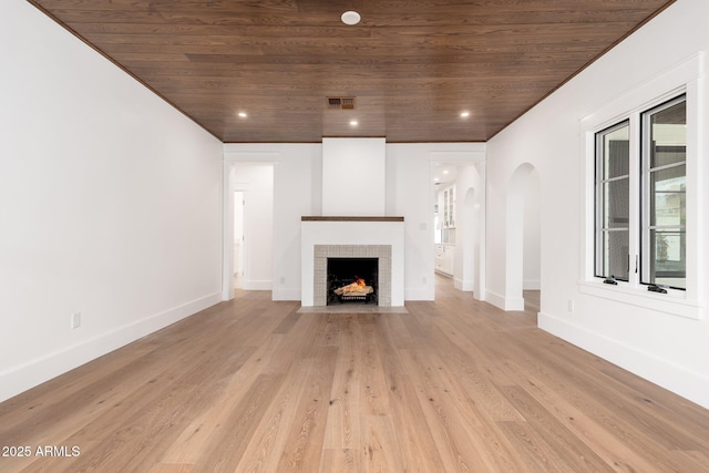 unfurnished living room featuring light hardwood / wood-style flooring and wooden ceiling