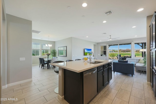 20702 W Hillcrest Blvd, Buckeye, AZ 85396 - kitchen featuring stainless steel dishwasher, open floor plan, light countertops, a ceiling fan, and a chandelier