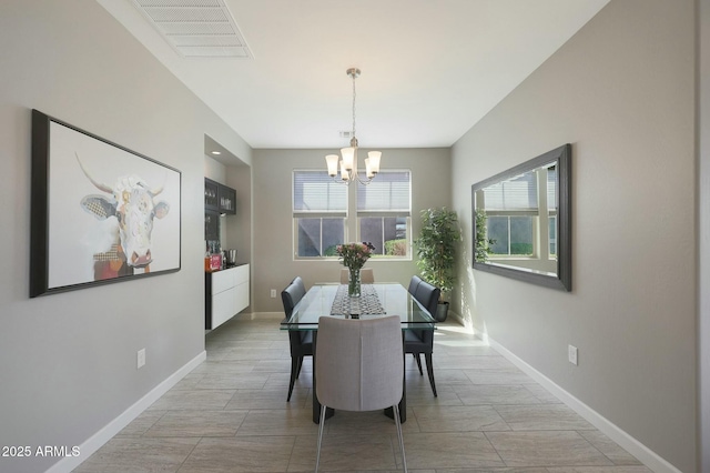 20702 W Hillcrest Blvd, Buckeye, AZ 85396 - dining area featuring a chandelier and baseboards