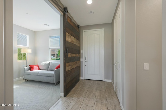 20702 W Hillcrest Blvd, Buckeye, AZ 85396 - foyer entrance with a barn door and wood tiled floors