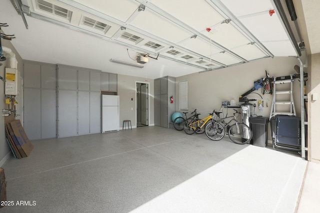 20702 W Hillcrest Blvd, Buckeye, AZ 85396 - garage with freestanding refrigerator and a garage door opener